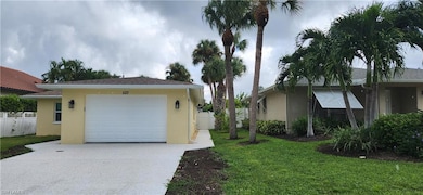 View of home's exterior featuring a garage and a l