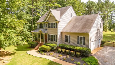 View of front facade with a garage, a front yard, and a porch