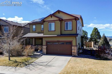 Craftsman house featuring a garage, stone siding, 
