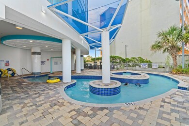View of swimming pool with a patio and a hot tub