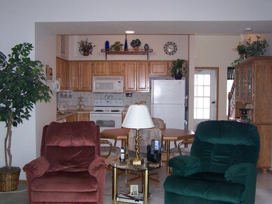 View of living room and kitchen.
