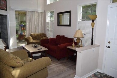 The (11.5'x16') Great Room. Front door is on the right. Screened-in porch is in the back middle, and Master bedroom entrance is in the back left