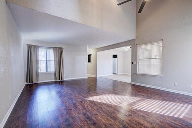 Unfurnished living room featuring a high ceiling, 