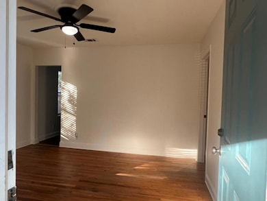 Empty room featuring dark wood-style floors and a