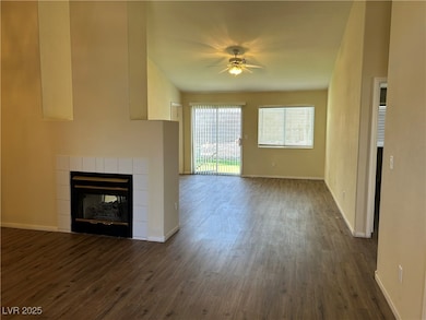 Unfurnished living room featuring ceiling fan, dar