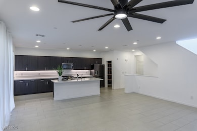 Kitchen with stainless steel microwave, light coun
