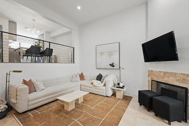 Tiled living room with a chandelier, a tiled firep