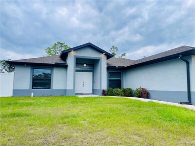 View of front facade featuring stucco siding, a front lawn, and roof with shingles