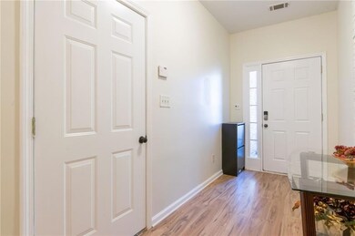 Entrance foyer with light hardwood / wood-style fl