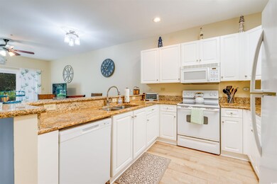 Kitchen featuring light wood-type flooring, white 