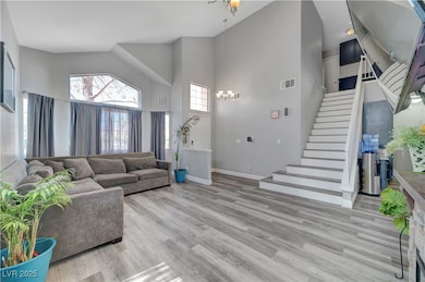 Living area with a chandelier, high vaulted ceilin
