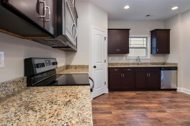 Natural Granite Countertops line the stainless steel appliances to make this Kitchen one to be proud of