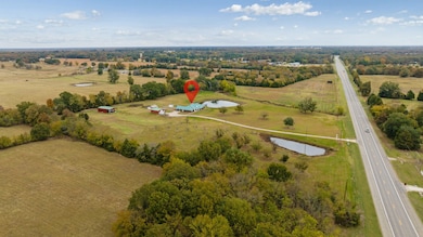 Aerial overview of property's location featuring a large body of water and rural landscape
