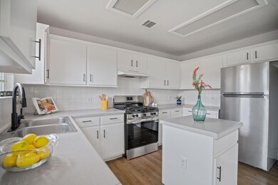 Kitchen featuring stainless steel appliances, a s