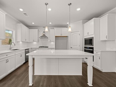 Westerly updated kitchen with a larbe quartz topped center island for bar seating