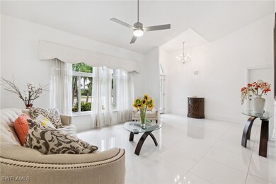 Living area with light tile patterned floors, a ch
