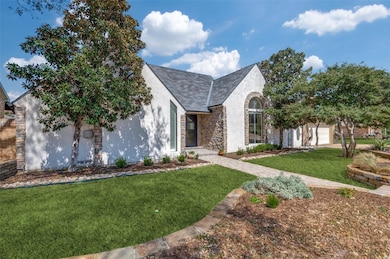 View of front of house featuring a front lawn, sto