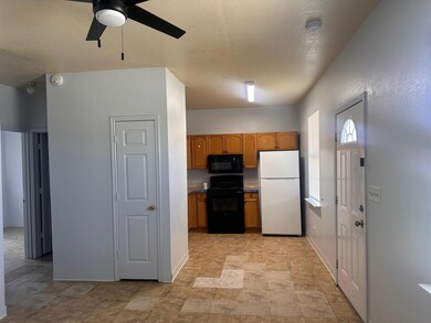 Kitchen featuring black appliances, a ceiling fan