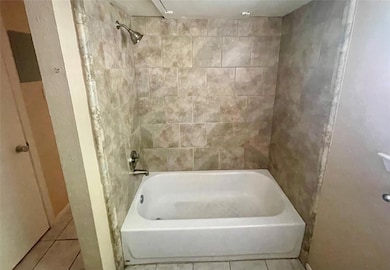 Full bathroom featuring tile patterned flooring a