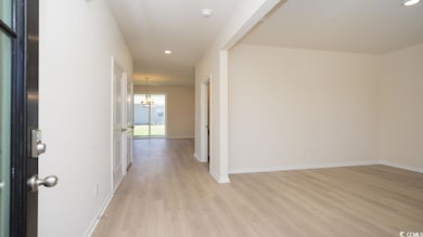 Corridor with baseboards, light wood-type flooring