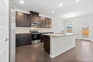 Kitchen featuring stainless steel appliances, a s