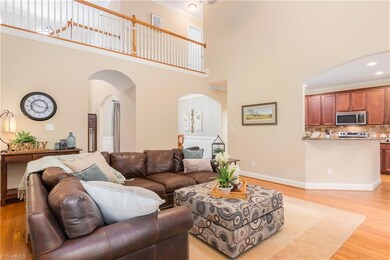 Living room area neutral light paint and view of the second floor.