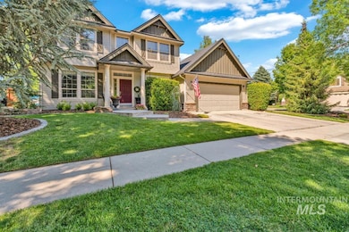 Craftsman-style home featuring board and batten siding, driveway, an attached garage, a front lawn, and stone siding