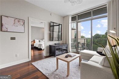 Living room with dark wood-style flooring and a wall of windows