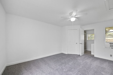 This bright bedroom features clean white walls, pl