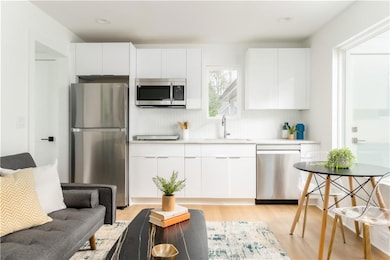 Kitchen with appliances with stainless steel finis