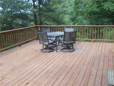 Exterior Front. Relax with the quiet sounds of the flowing water on this enormous wood deck over looking the river.