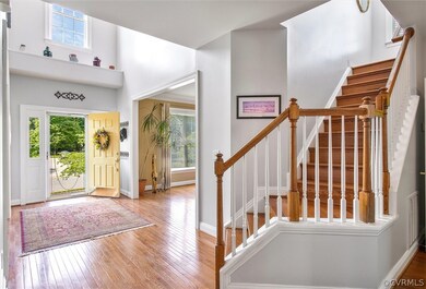 Foyer/entry area view to living room and stairs to