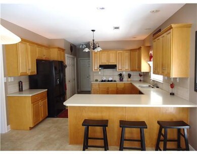 Kitchen. Breakfas bar, lots of cabinets and counte