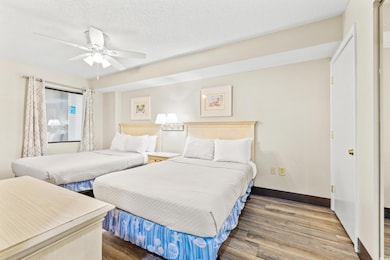 Bedroom featuring a textured ceiling, wood-type fl