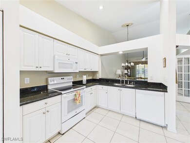 Kitchen featuring white appliances, light tile pat
