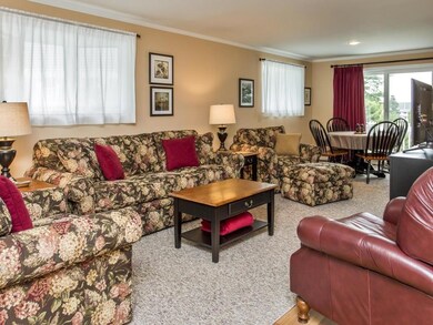 Living room with two bay windows,...