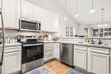 Kitchen with stainless steel appliances, hanging l