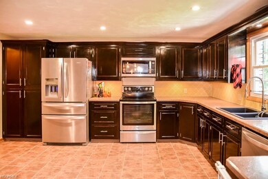 The kitchen has tons of cabinet storage plus a pan