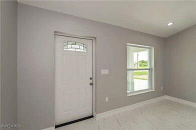Entryway with recessed lighting, marble finish flo