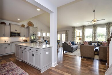 Kitchen and Great Room with lots of natural lighting! Photo for representation only. 