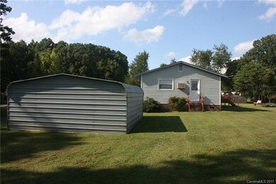Side view of home and detached 20'x20' out buildin