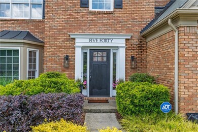 View of exterior entry with brick siding