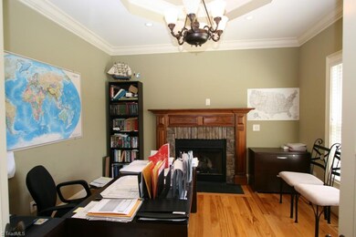Office with gas fireplace and octagon tray ceiling.