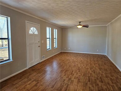 Foyer featuring visible vents, ceiling fan, a weal