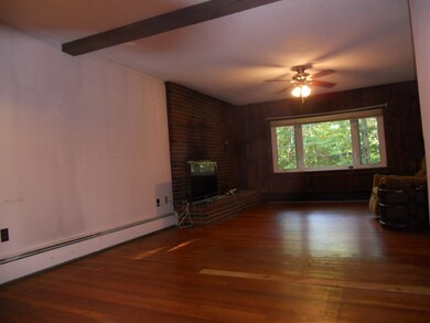 Living Room with brick fireplace/ Dining Room