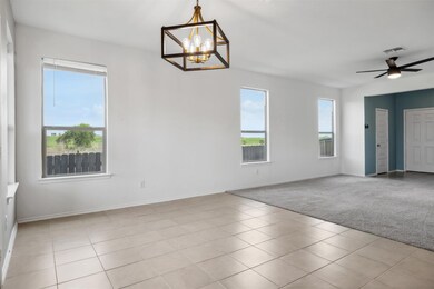 Tiled empty room with a chandelier, carpet floori
