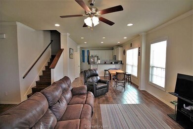 Living room featuring ceiling fan, wood-type floor