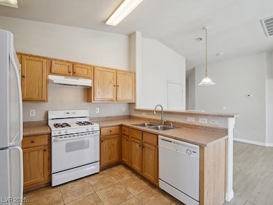 Kitchen featuring white appliances, under cabinet