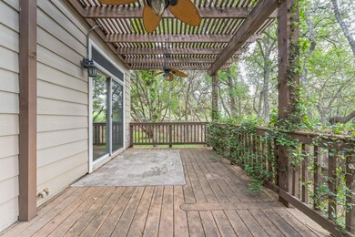 Wooden deck with a ceiling fan and a pergola
