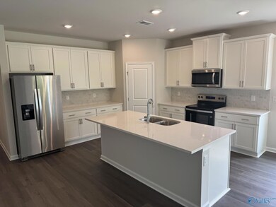 Look at that cabinet space! Quartz countertops, tile backsplash, 42